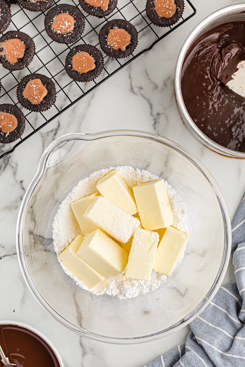 Overhead view of butter and powdered sugar in mixing bowl