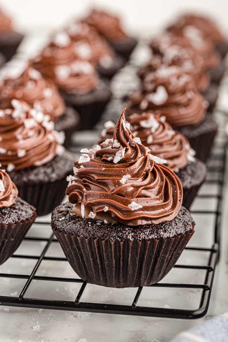 Chocolate salted caramel mini cupcakes on cooling rack