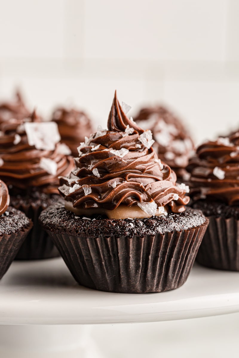 Closeup of chocolate salted caramel mini cupcakes on cake stand