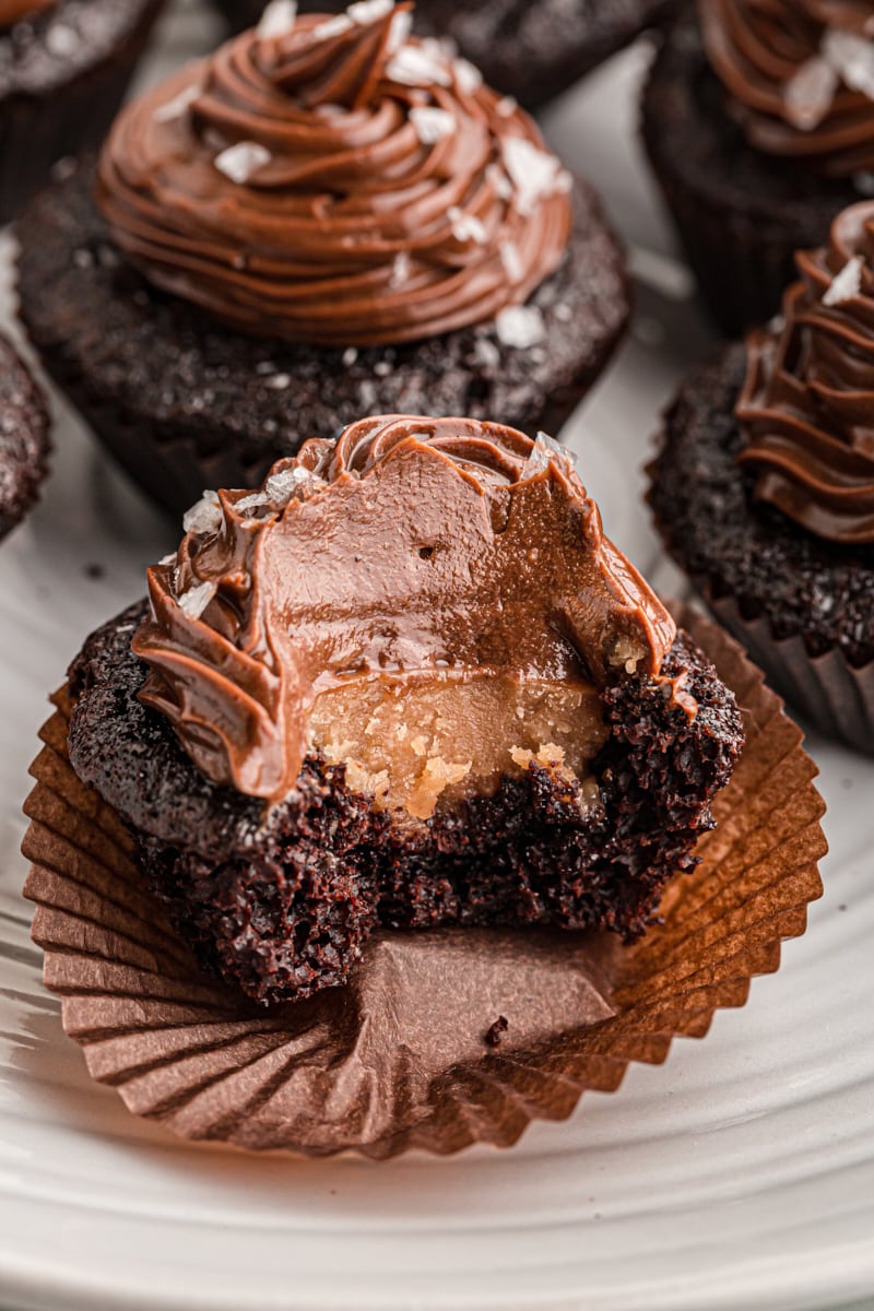 Chocolate salted caramel mini cupcake with bite taken out to show filling