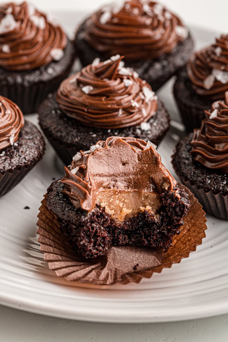 Chocolate salted caramel mini cupcake with bite taken out to show filling