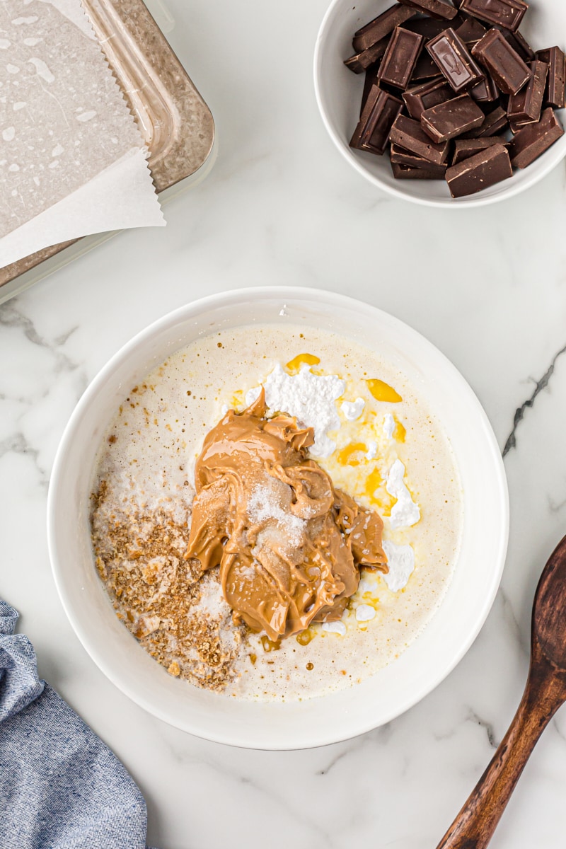 Overhead view of peanut butter layer ingredients in mixing bowl