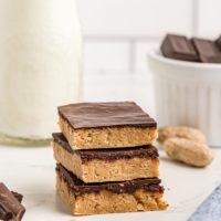 Three stacked no-bake peanut butter chocolate bars
