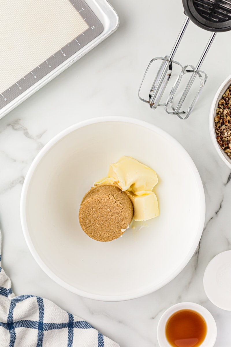 Overhead view of brown sugar and butter in a mixing bowl.