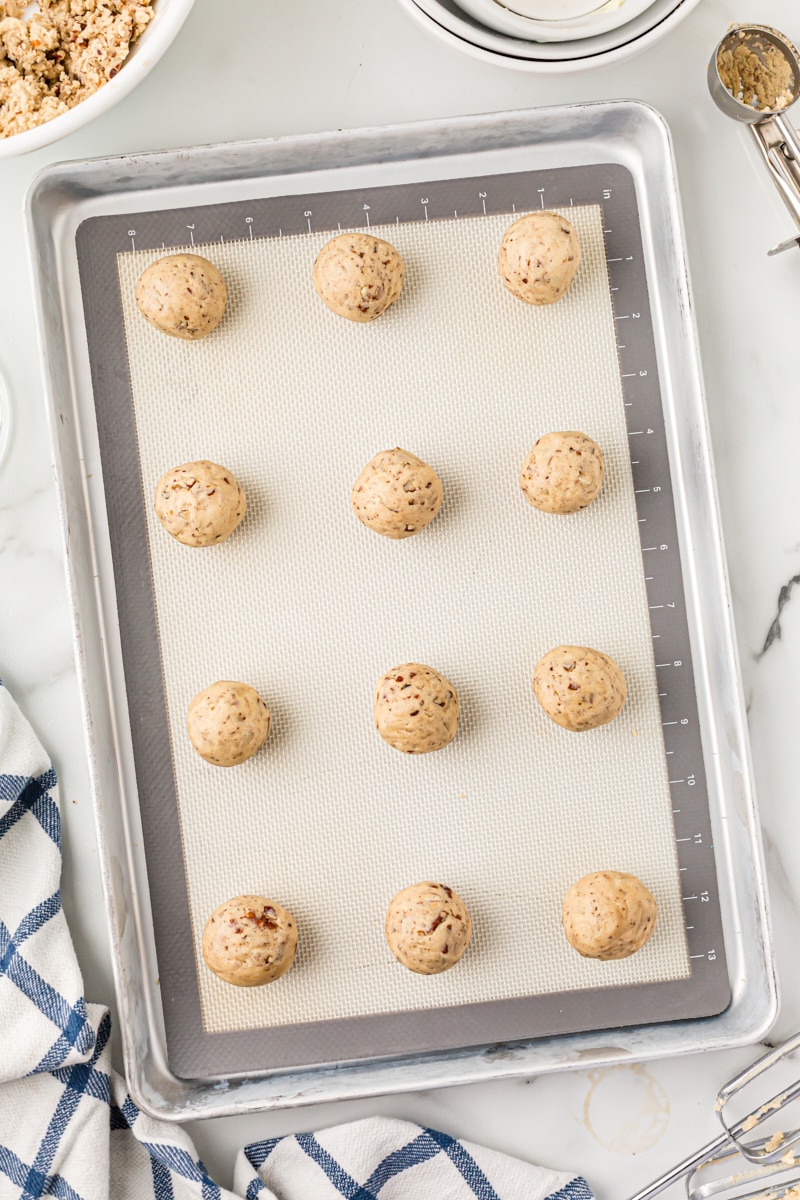 Overhead view of dough balls on baking sheet.