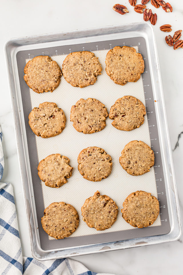 Overhead view of pecan sandies on a baking sheet.