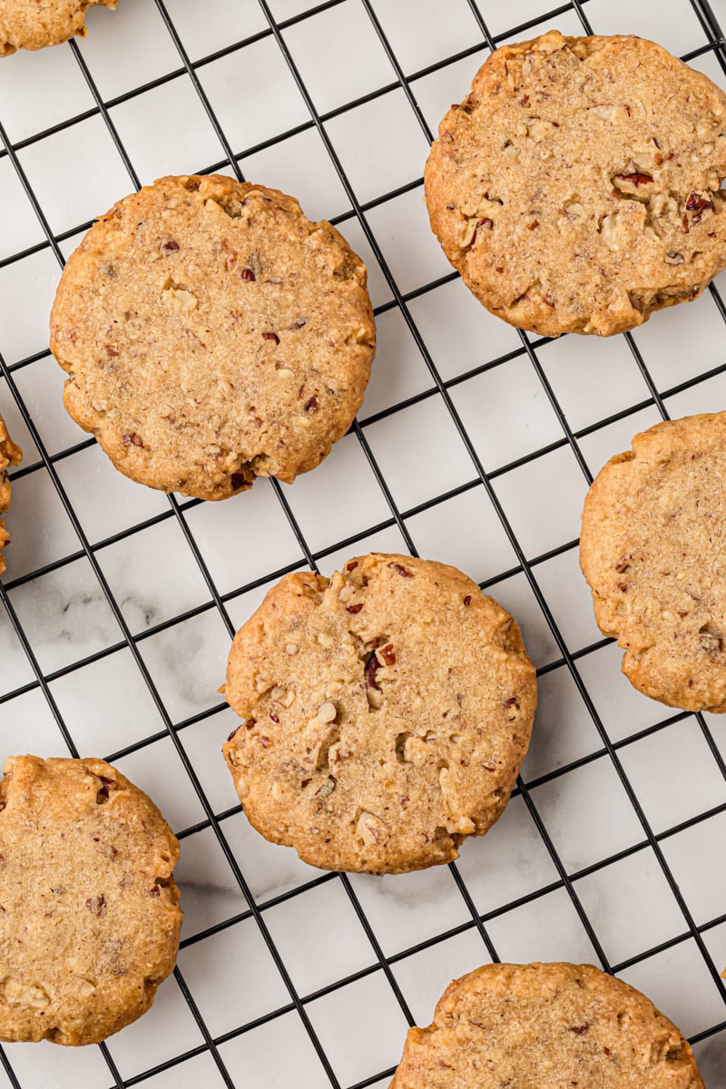 Overhead view of pecan sandies cooling on rack.