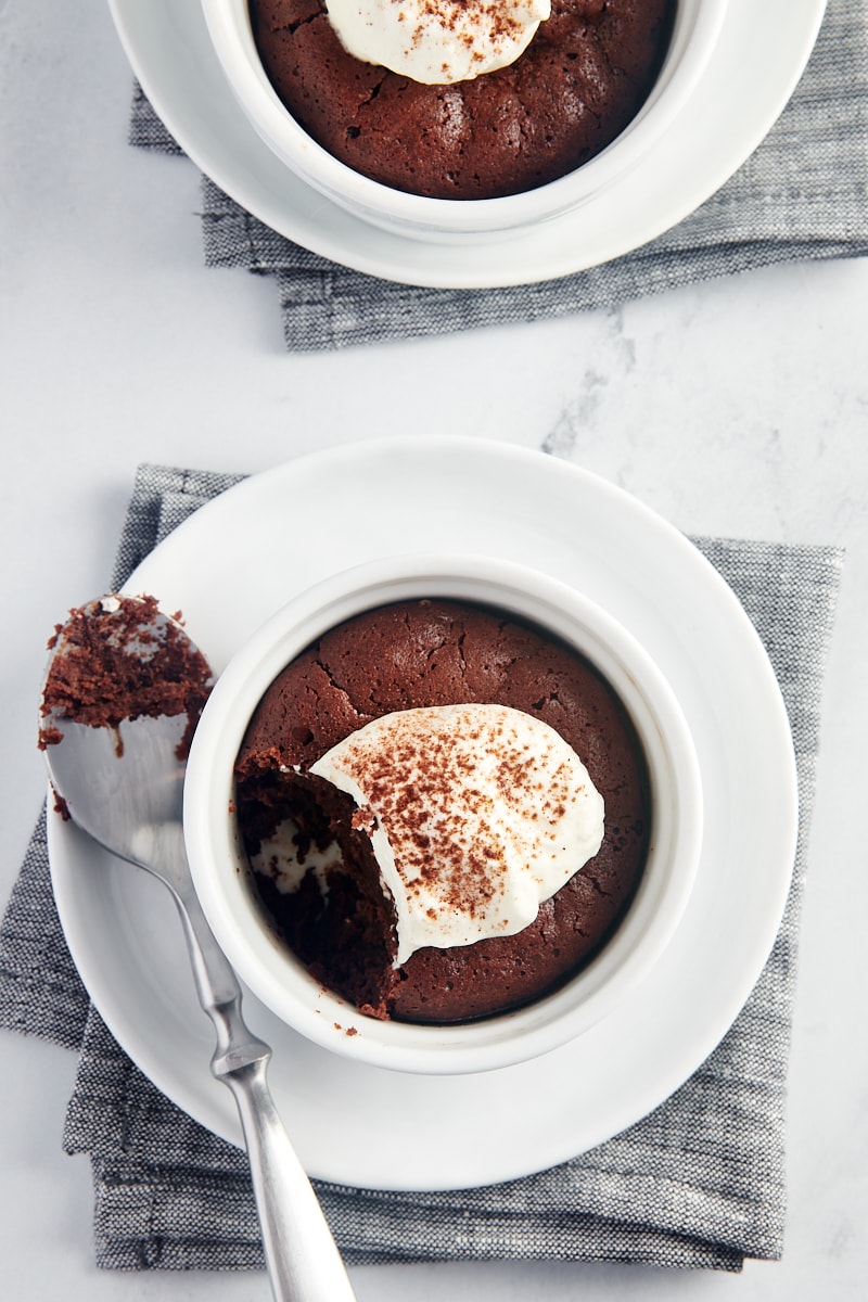 overhead view of Flourless Chocolate Cakes for Two with a bite on a spoon resting next to one of the servings