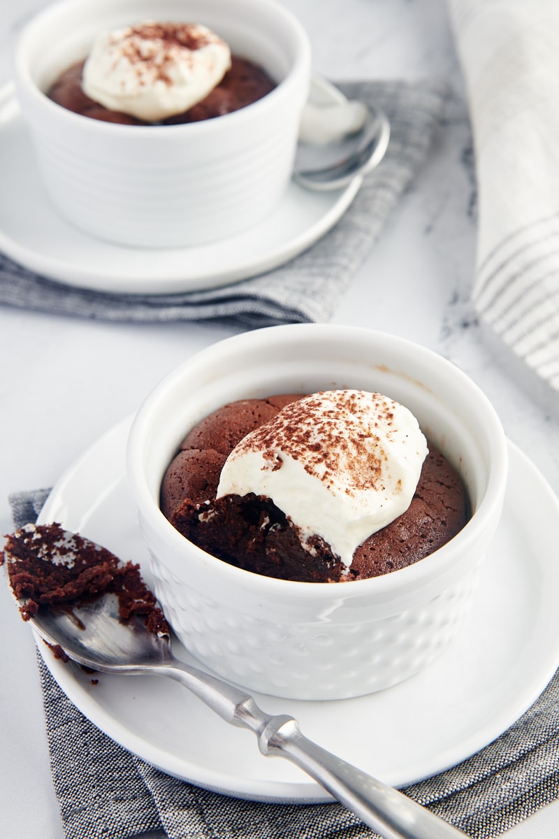 Flourless Chocolate Cakes for Two served in white ramekins set on white plates