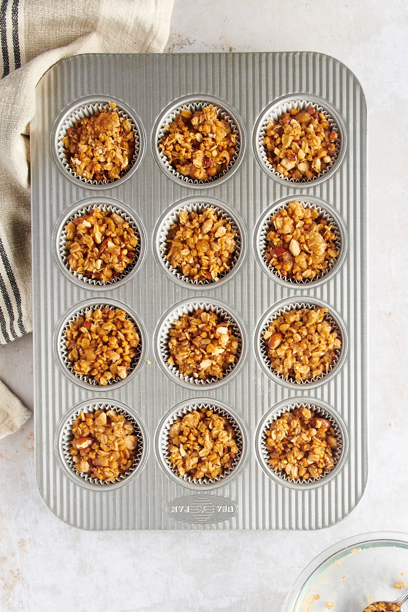 Overhead view of unbaked granola yogurt muffins in pan