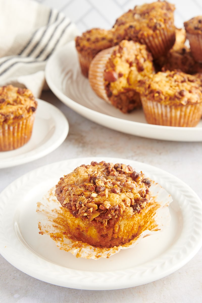 Granola yogurt muffin on white plate with wrapper removed