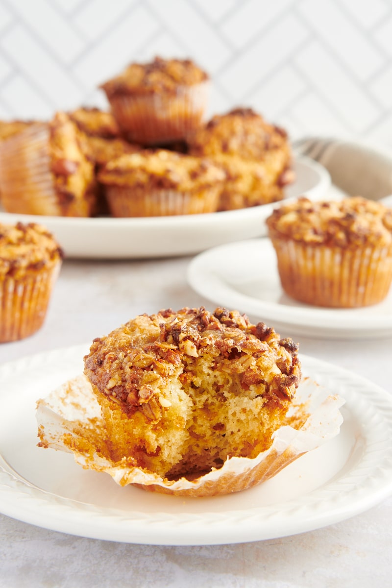 Granola yogurt muffin on white plate with wrapper removed