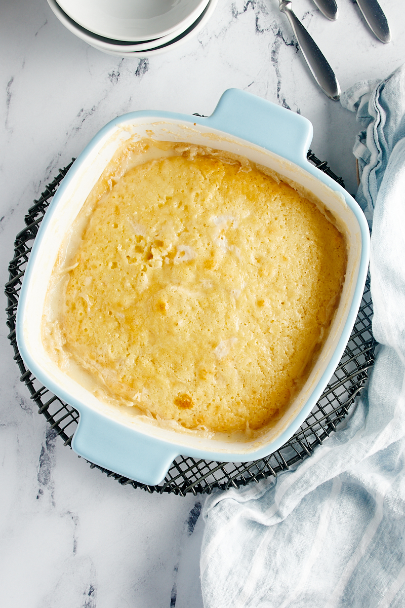 overhead view of freshly baked Vanilla Pudding Cake on a wire cooling rack