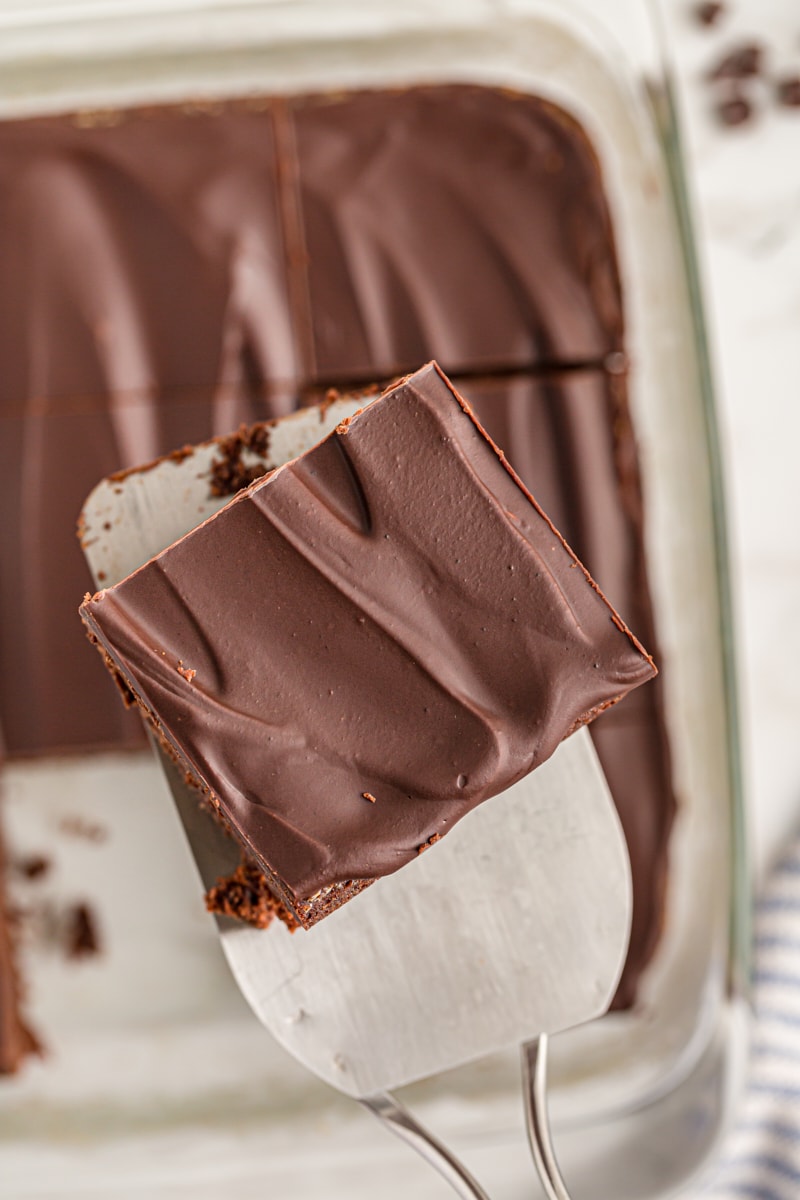 Spatula holding chocolate mascarpone brownie over pan