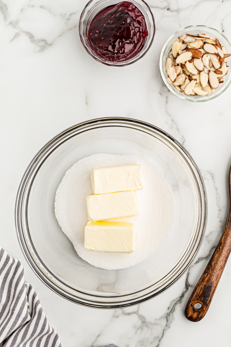 overhead view of butter and sugar in a glass mixing bowl