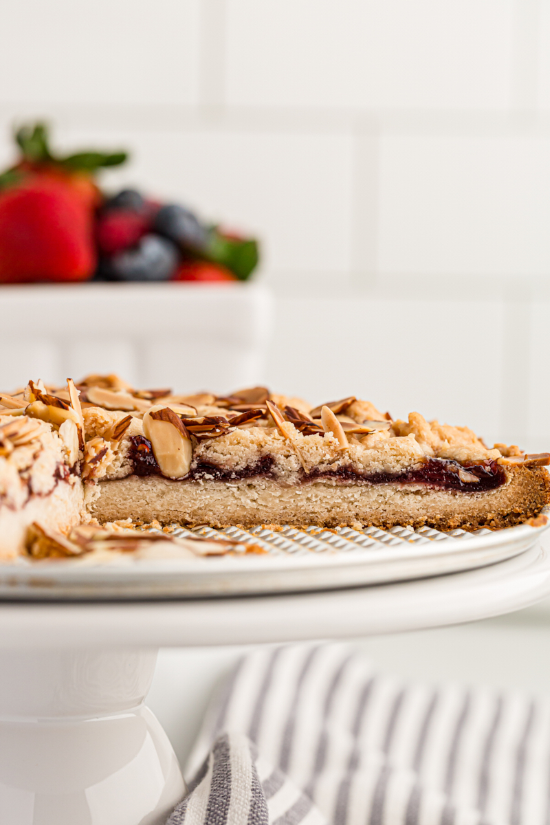 partial Italian Jam Crostata on a white cake stand