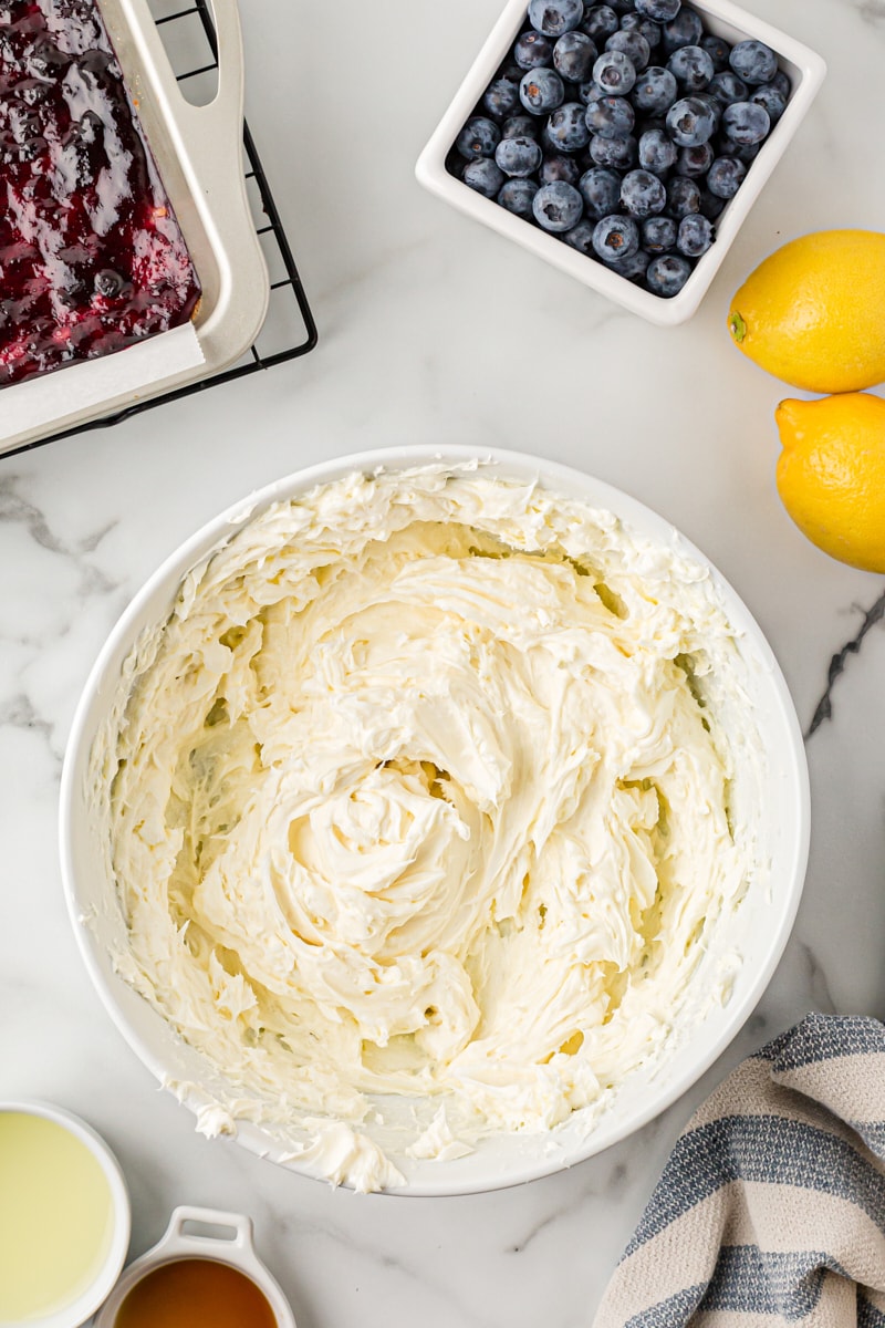 Overhead view of creamed cream cheese in mixing bowl