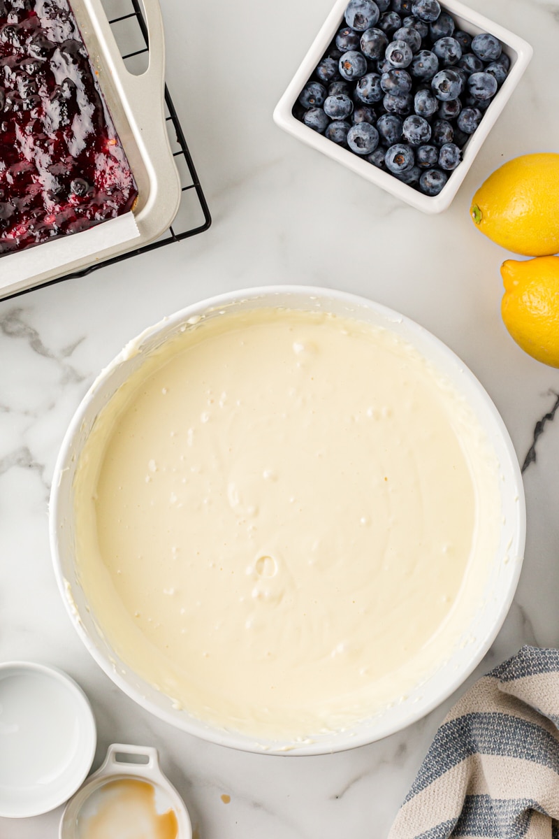 Overhead view of lemon cheesecake mixture in large mixing bowl