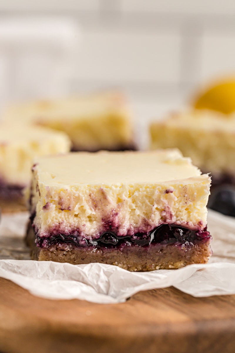 Side view of lemon blueberry cheesecake bar, showing layers