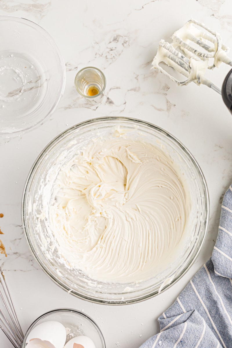 Overhead view of cream cheese frosting in glass mixing bowl