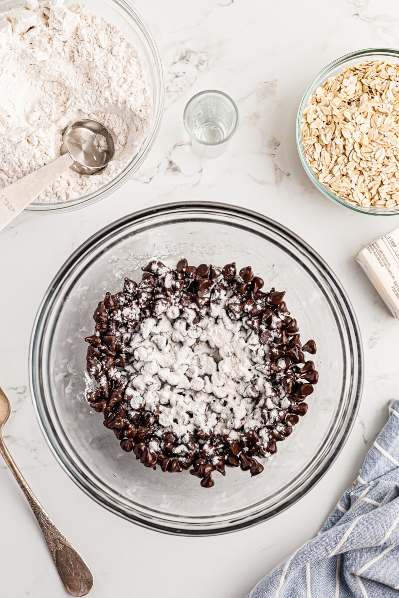 Overhead view of flour added to bowl of chocolate chips