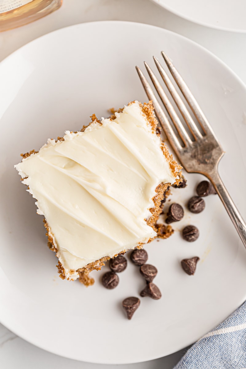 Overhead view of oatmeal chocolate chip cake on plate with corner eaten