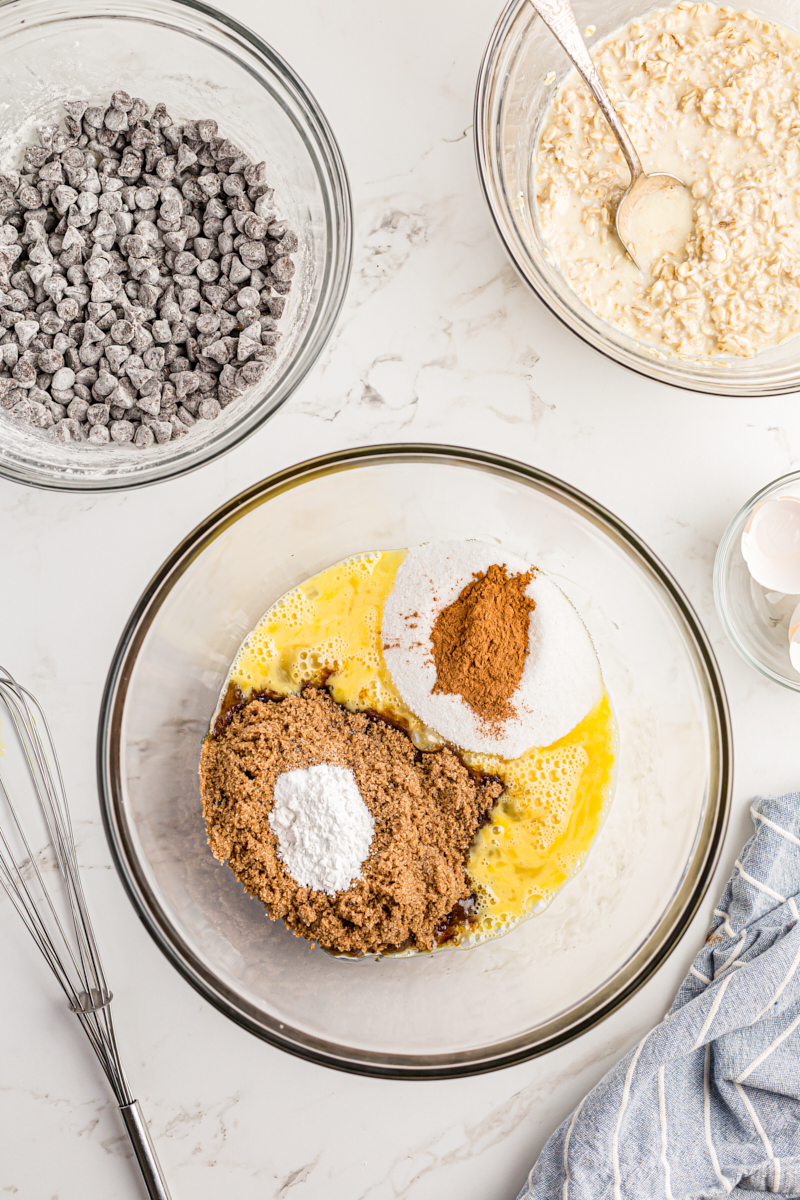 Overhead view of ingredients for oatmeal chocolate chip cake in mixing bowl