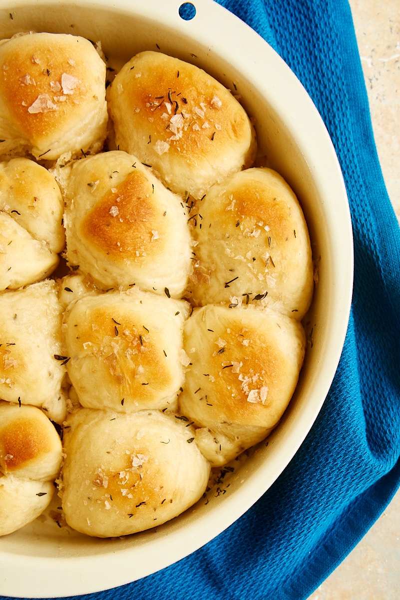 overhead view of brown and serve rolls in a round cake pan