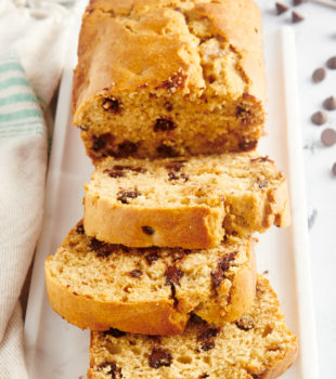 Chocolate chip peanut butter bread on platter with 3 slices cut