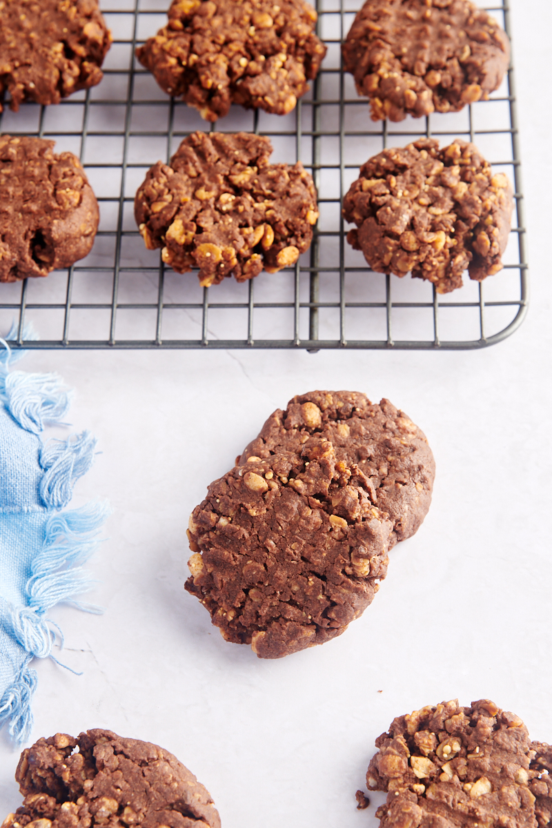 Chocolate peanut butter granola cookies on cooling rack and tabletop