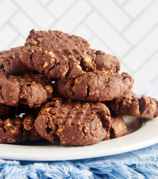 Chocolate peanut butter granola cookies stacked on plate