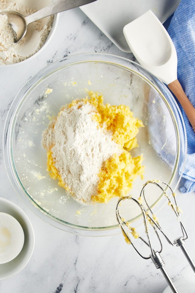 overhead view of flour added to cookie dough