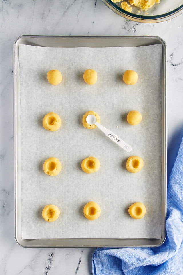 overhead view of indentations being made in thumbprint cookie dough