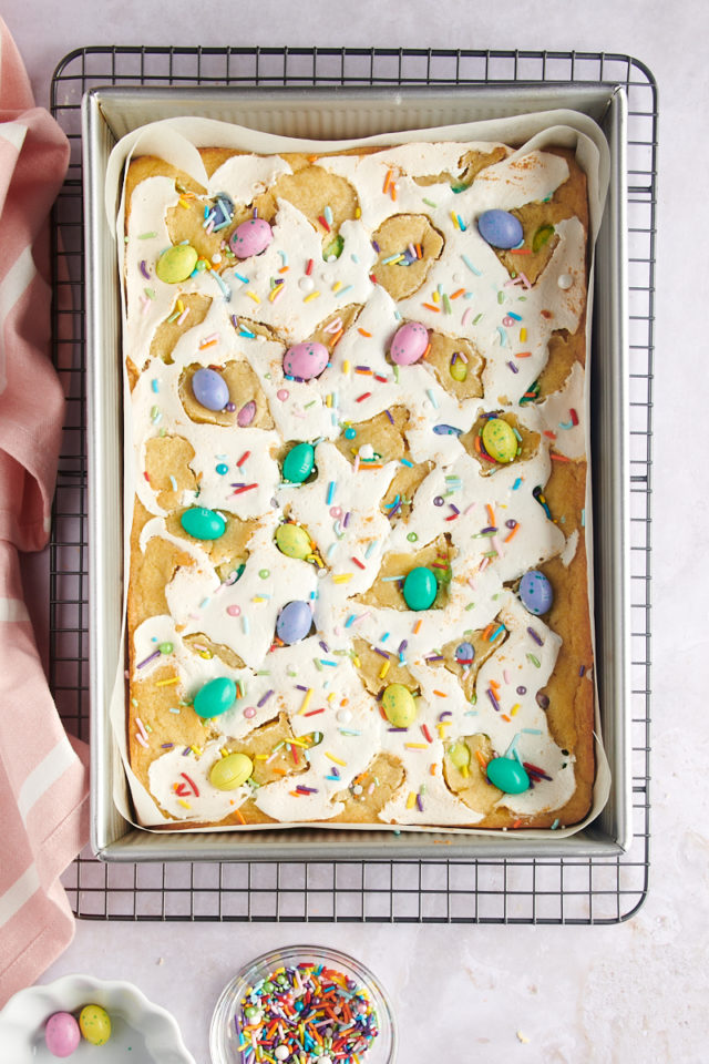 overhead view of M&Ms and sprinkles added to the top of M&M Marshmallow Sugar Cookie Bars in a 9x13 pan
