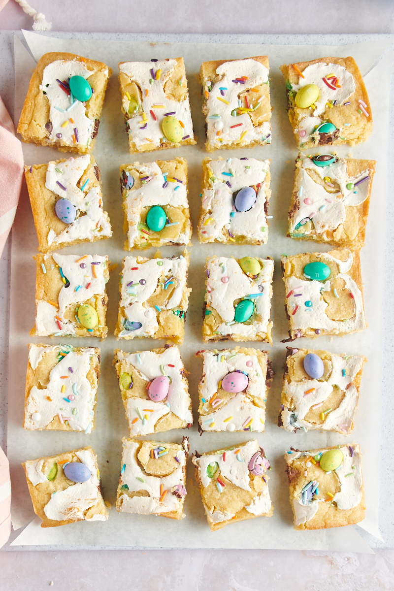overhead view of sliced M&M Marshmallow Sugar Cookie Bars on parchment paper