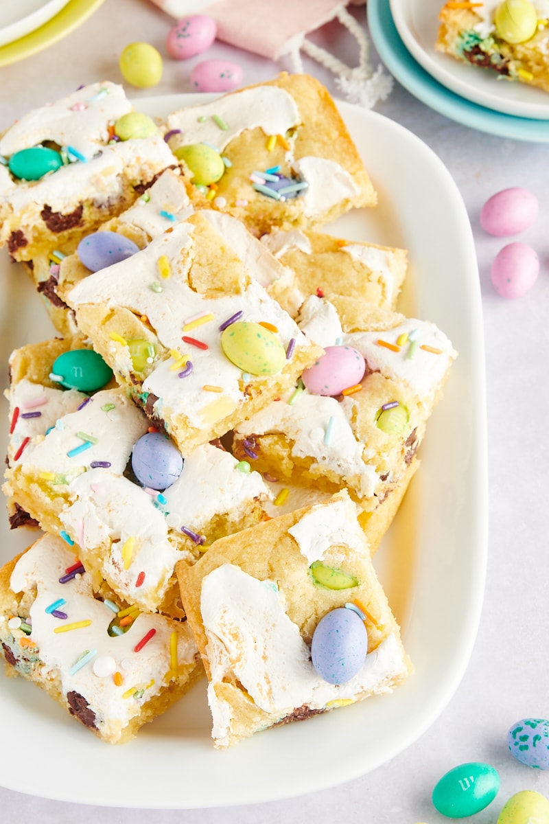 M&M Marshmallow Sugar Cookie Bars on a white serving platter surrounded by more M&Ms