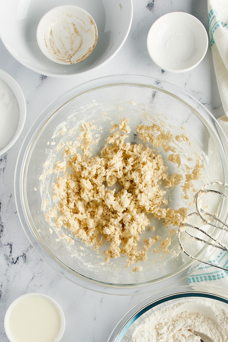 Overhead view of a butter and vanilla mixture in a glass bowl.