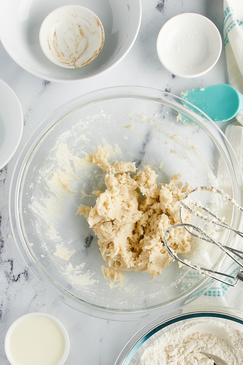 Overhead view of creamed butter in a mixing bowl.