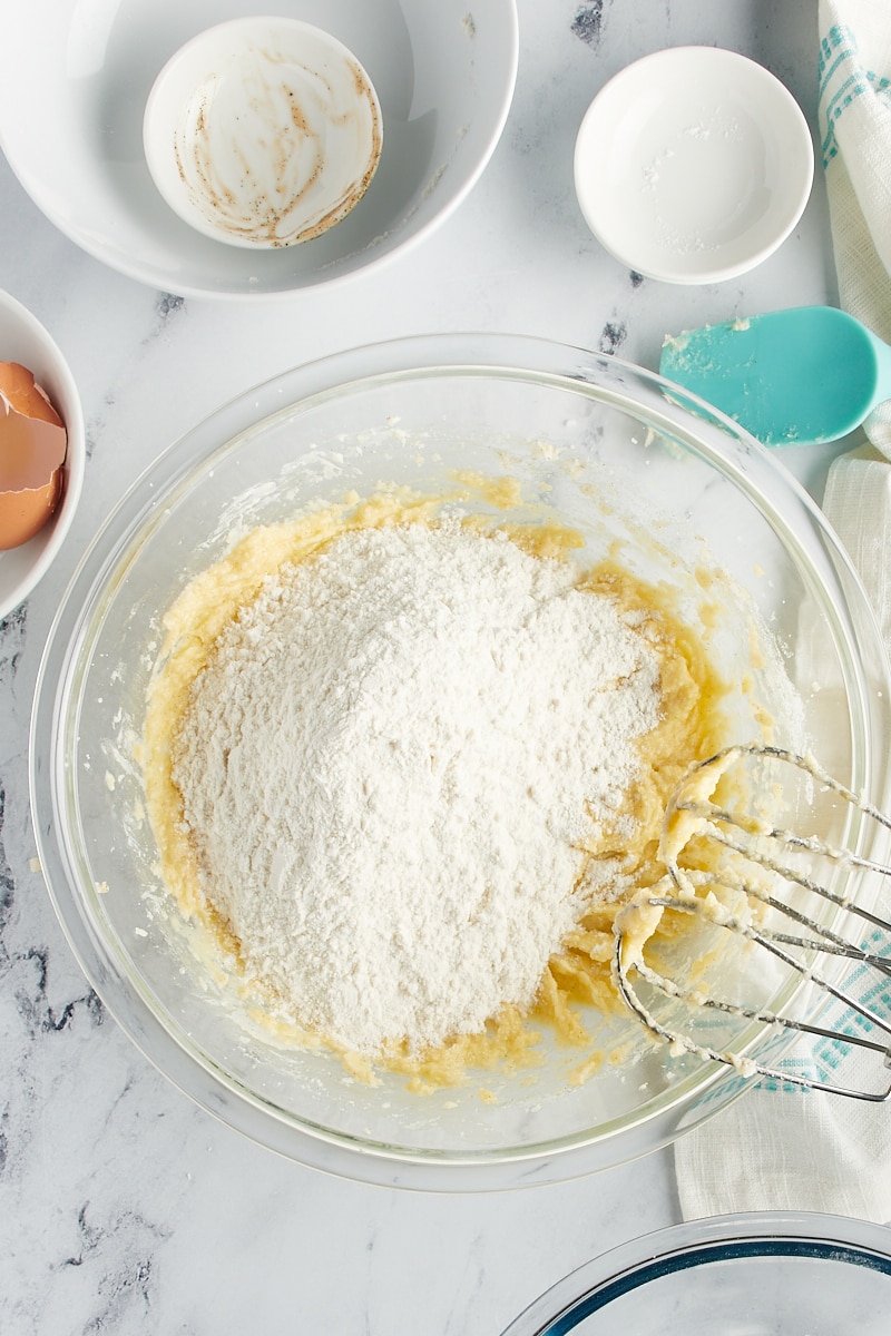 Overhead view of dry ingredients added to wet cookie ingredients.