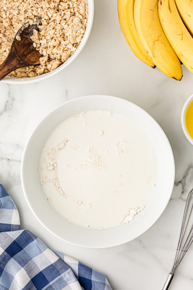 Overhead view of milk and dry ingredients for batter in mixing bowl