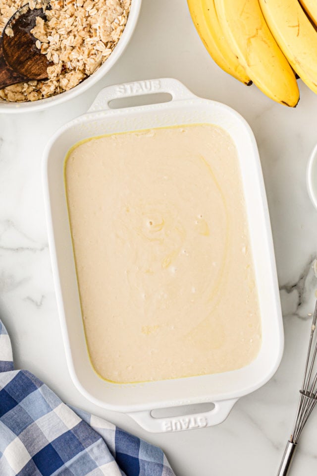 Overhead view of batter in white baking dish