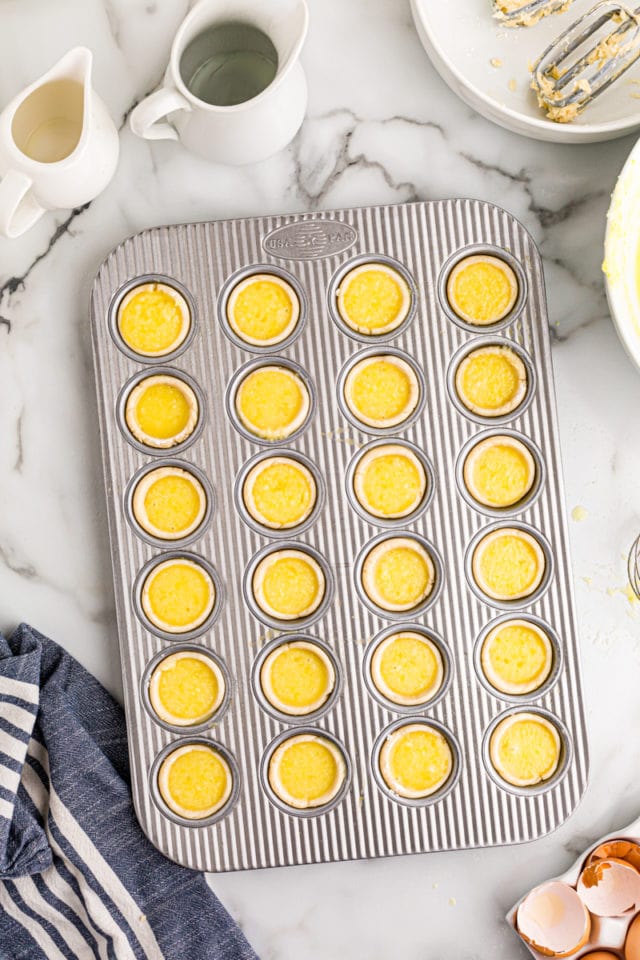 overhead view of Lemon Chess Tartlets in a mini muffin pan ready to go into the oven