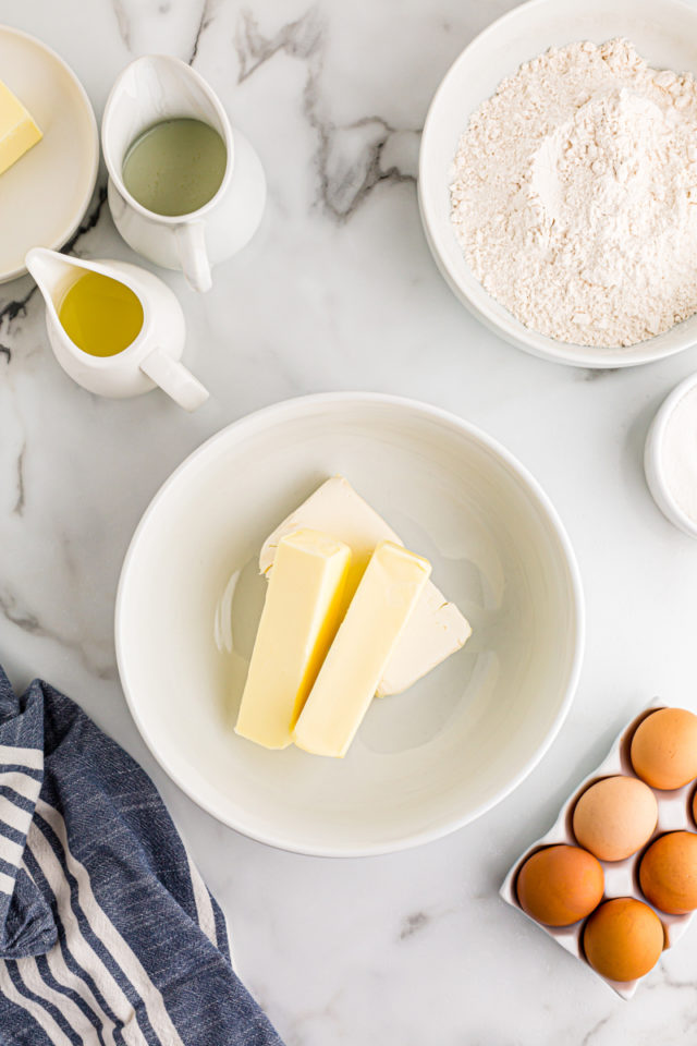 overhead view of butter and cream cheese in a white mixing bowl