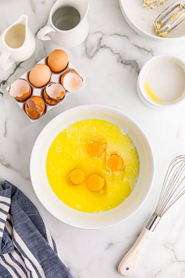 overhead view of lemon chess filling ingredients in a white mixing bowl