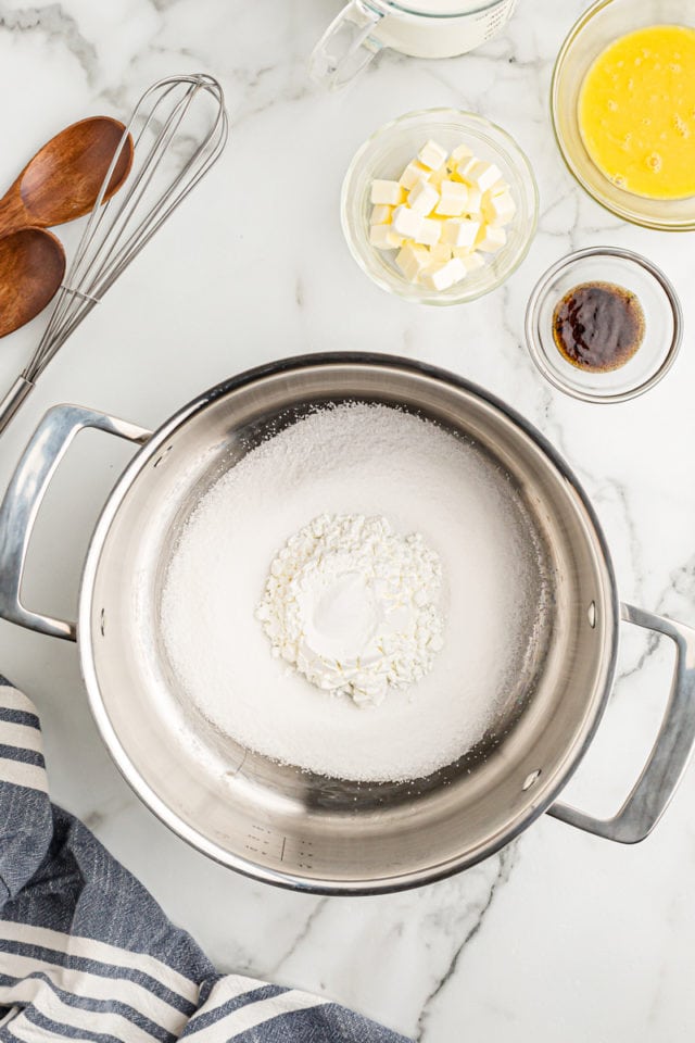 Overhead view of dry ingredients for vanilla pudding in pan