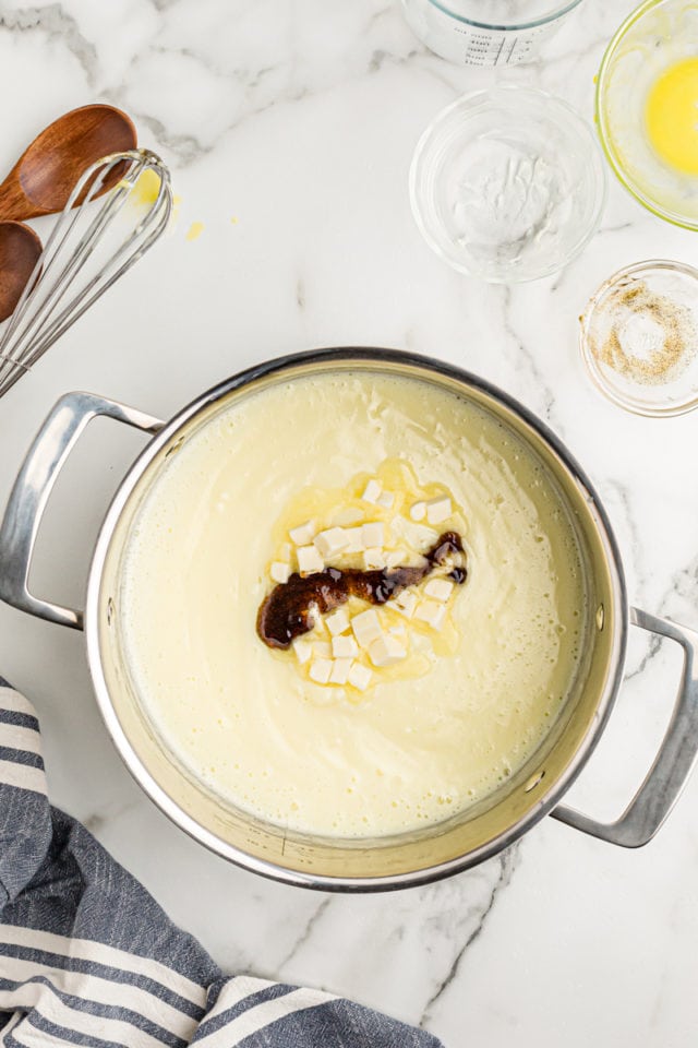 Adding butter and vanilla to pan of pudding