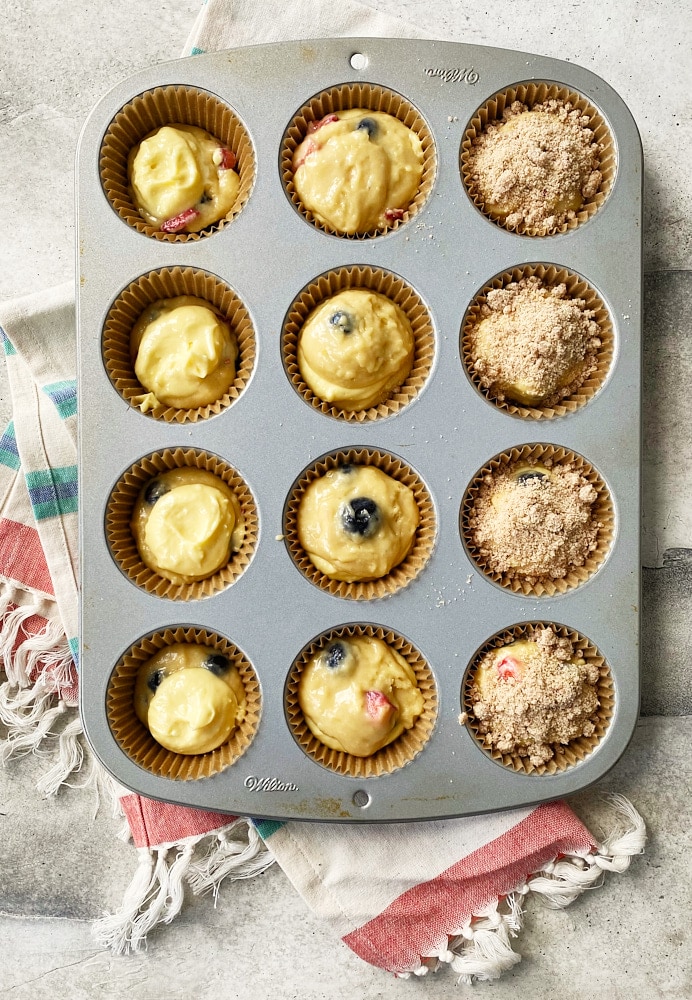 overhead view of Berry Cheesecake Muffin batter in a muffin pan