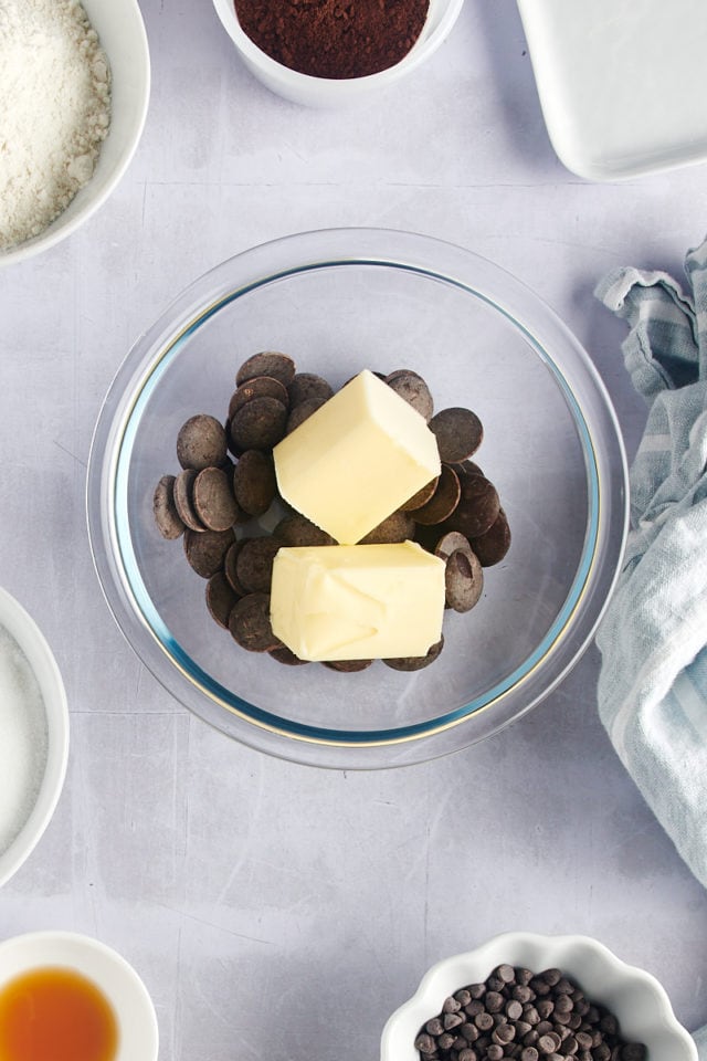 Overhead view of chocolate and butter in glass bowl