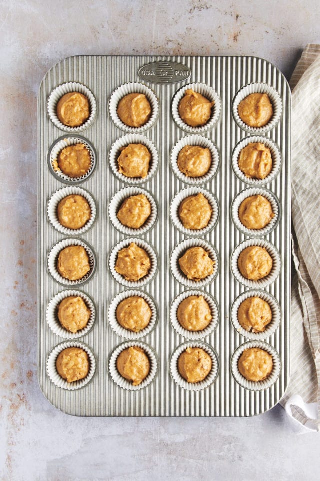 Overhead view of muffin batter in pan before adding sugar topping