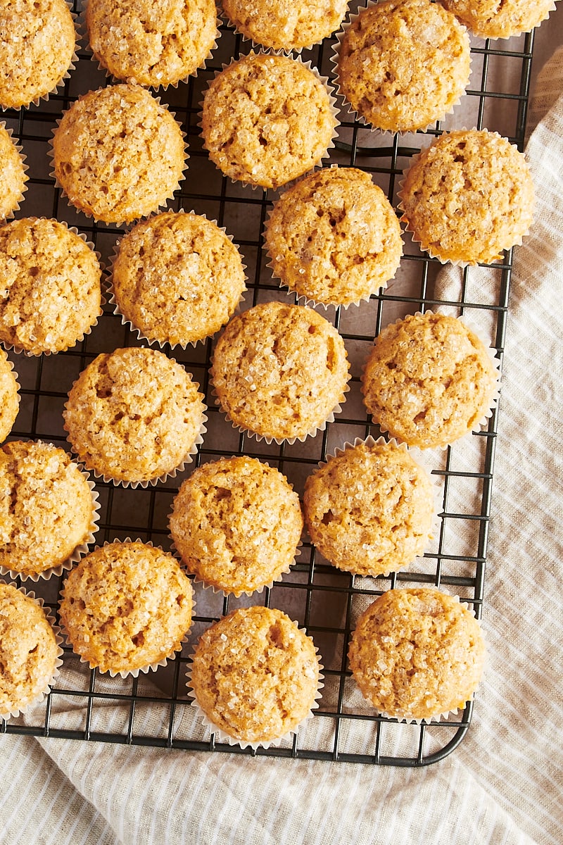 Overhead view of cinnamon mini muffins on cooling rack